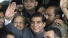 Pakistan's Prime Minister Raja Pervaiz Ashraf waves upon arriving at the Supreme Court for a hearing where he will submit his reply regarding the court's order to reopen an old corruption case against the country's president, in Islamabad, Pakistan, Sept.