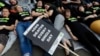 FILE - Supporters stage a 'Die-In' to mark World Hepatitis Day at Piccadilly Circus in London.