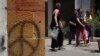 People cross the Ledra street crossing point that leads from the north to the south between the U.N buffer zone in the divided capital Nicosia, Cyprus, June 28, 2017. 