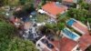 A drone view shows people working at the site of a plane crash in Vinhedo, Sao Paulo, Brazil, Aug. 10, 2024.
