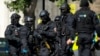 Near the start of a training exercise for London's emergency services, armed police officers stand near the Aldwych underground train station in London, June 30, 2015.