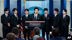 FILE - RM, center, and other K-pop supergroup BTS members at daily briefing at the White House in Washington, May 31, 2022.