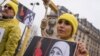 FILE - A demonstrator poses with a symbolic rope around her neck as Iranian opposition protesters march during a rally to protest against executions in Paris, France.