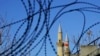 Turkish and Turkish Cypriot breakaway flags are seen through the barbed wires by the U.N. buffer zone that divides the Greek and Turkish Cypriots controlled areas, in the divided capital Nicosia, Mediterranean island of Cyprus, Jan. 12, 2017.