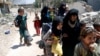 Displaced civilians walk towards the Iraqi Army positions after fleeing their homes due to clashes in the Shifa neighbourhood in western Mosul, Iraq, June 15 2017. 