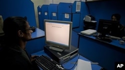 FILE - People use an internet cafe in Pakistan, March 7, 2012. While internet and social media services across Pakistan are regularly disrupted to prevent dissent, Pakistan said July 30, 2024, that engineers have created a messaging app for secure communication among officials.