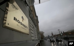 FILE - A plaque for the Rosneft Oli Company is seen outside the company headquarters in Moscow, Russia, Oct. 18, 2012.