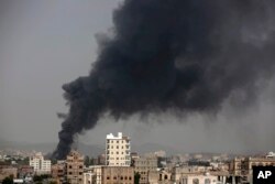 FILE - Smoke rises after Saudi-led airstrikes hit a food factory in Sana'a, Yemen, Aug. 9, 2016.