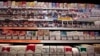 FILE - Cigarette packs are seen on shelves in a tobacco shop in Cagnes-sur-Mer, France, Sept. 8, 2015. The World Health Organization on Tuesday called on countries do adopt plain packaging to make tobacco products less attractive and reduce deaths from smoking.