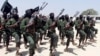 FILE - hundreds of newly trained al-Shabab fighters perform military exercises in the Lafofe area some 18 km south of Mogadishu, in Somalia. 