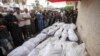 Mourners pray at the funeral for people killed in an Israeli strike, at Al-Aqsa Martyrs Hospital in Deir al-Balah, Gaza Strip, Aug. 17, 2024. The strike hit a house and adjacent warehouse sheltering displaced people at the entrance of the town of Zawaida, health officials said.