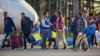 FILE - Eritrean migrants arrive at Lulea airport, Kallax, Sweden, having flown from Rome's Ciampino airport, Oct. 9, 2015.