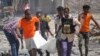 Sejumlah warga dan petugas penyelamat mengevakuasi jenazah seorang warga sipil yang tewas akibat sebuah ledakan di Mogadishu, Somalia, pada 12 Januari 2022. (Foto: AP/Farah Abdi Warsameh)