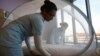 Nurses set up a mosquito tent over a hospital bed, as part of a precautionary protocol for patients who are infected by Zika at Farrer Park Hospital in Singapore Sept. 2, 2016
