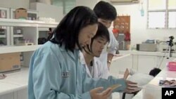 FILE - Women scientists are seen working in research lab in Jakarta, Indonesia.