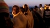 Men stand on the deck of the rescue vessel Golfo Azzurro after being rescued by Spanish NGO Proactiva Open Arms workers on the Mediterranean Sea, June 16, 2017. 