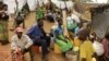 FILE - Newly arrived Mozambican refugees wait for registration at the Kapise refugee camp in the Mwanza district on the Malawian Mozambican border, Jan. 7, 2015, in Malawi.