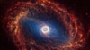 La galaxia espiral NGC 1512, ubicada a 30 millones de años luz de la Tierra, se ve en una imagen sin fecha del Telescopio Espacial James Webb.