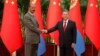 Chinese Premier Li Qiang, right, and Eritrean President Isaias Afwerki shake hands as they attend a meeting at the Great Hall of the People in Beijing, May 15, 2023. 