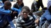 FILE - Migrants who attempted to flee to Europe wait in Libyan coast guard detention in the coastal city of Tripoli, Libya, May 16, 2016. 