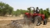 FILE - A farmer plows the field in Saulawa village, on the outskirts of Nigeria's north-central state of Kaduna.