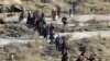 FILE - This Nov. 27, 2016 photo provided by the Rumaf, a Syrian Kurdish activist group, which has been authenticated based on its contents and other AP reporting, shows people fleeing rebel-held eastern neighborhoods of Aleppo into the Sheikh Maqsoud area that is controlled by Kurdish fighters in Syria.