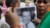 Mourners hold a portrait of Cambodian government critic Kem Ley during a funeral ceremony in Phnom Penh, Cambodia, Wednesday, July 13, 2016. A former Cambodian soldier was charged Wednesday with murder in the killing of Kem in a brazen attack that has raised accusations of a political conspiracy. (AP Photo/Heng Sinith)
