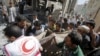 A medic and people carry the body of a boy following a Saudi-led air strike in Yemen's capital Sana'a, Sept. 22, 2015.