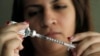 FILE - Judith Garcia fills a syringe as she prepares to give herself an injection of insulin at her home in the Los Angeles suburb of Commerce, Calif., April 29, 2012. The WHO reports diabetes is four times more common than it was in 1980, and now afflicts 422 million adults. 